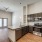 Spacious and well lit kitchen with wood flooring and stainless steel appliances