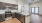 Spacious and well lit kitchen with wood flooring and stainless steel appliances