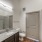 Bathroom with vanity and lighted mirror