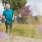 a man and woman running on a path in park